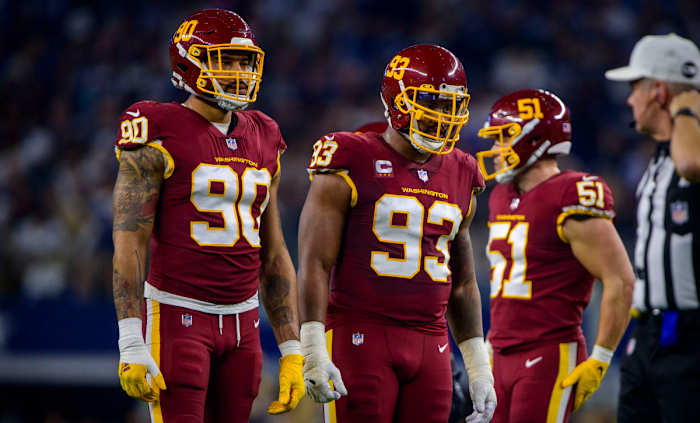 Washington Football Team defensive end Montez Sweat (90) and defensive tackle Jonathan Allen (93) wait for play to resume against the Dallas Cowboys at AT&T Stadium.